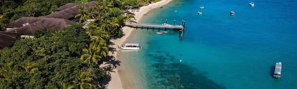 Aerial view of the beach, jetty and resort at Fitzroy Island, off Cairns