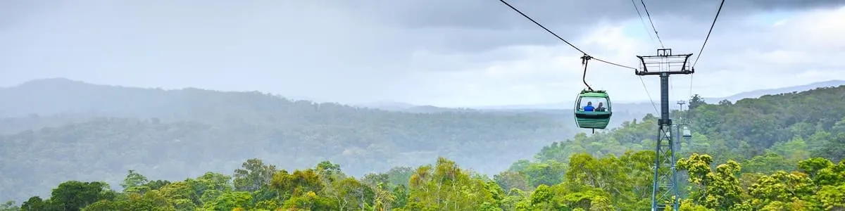 A cableway gondola crossing the rainforest canopy in the ranges behind Cairns
