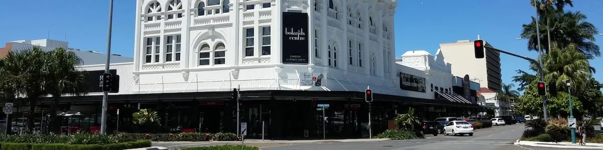 The heritage Bolands Centre building on a Cairns city street corner under a clear blue sky
